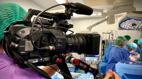videographer shooting in operation room