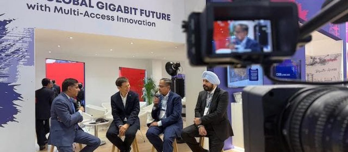 Camera with panelists in the background